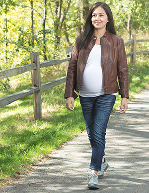 Pregnant woman outdoors walking.